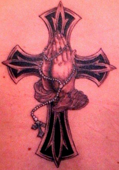 Preying hands with cross tattoo