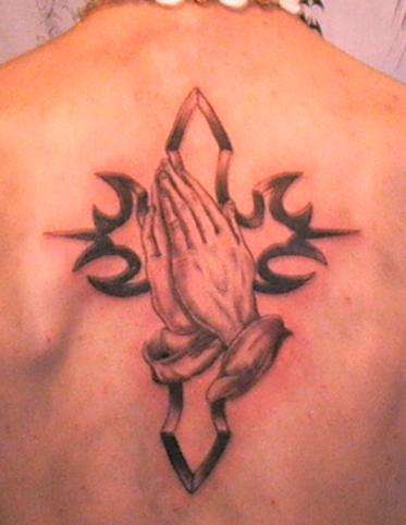 preying hads with cross tattoo