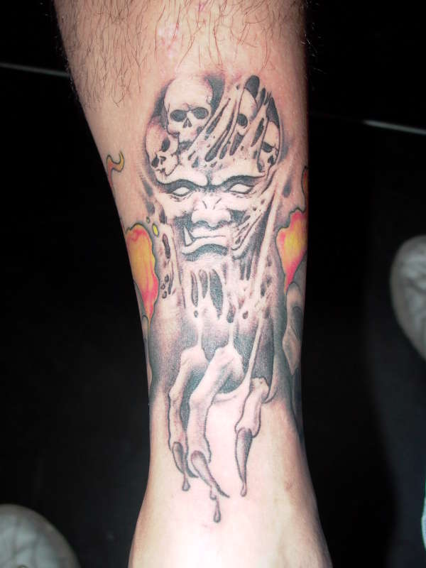 demon with skulls tattoo