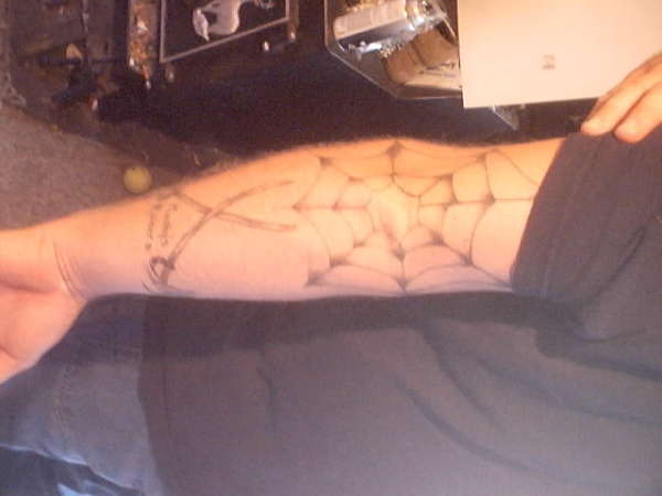 Spider web and crossed sabers tattoo