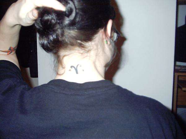 Aries symbol with nape peircing tattoo