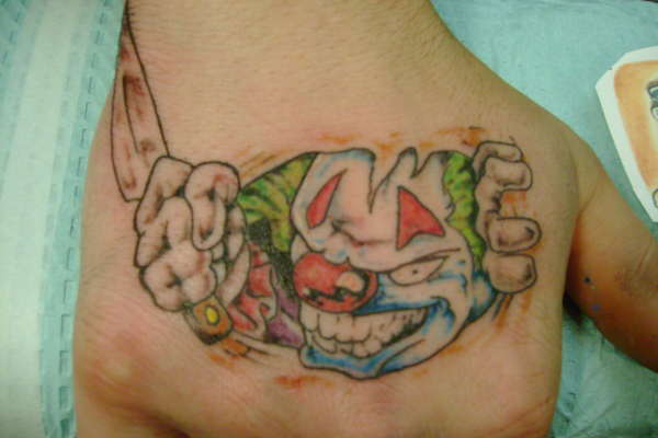 clowny hand tattoo