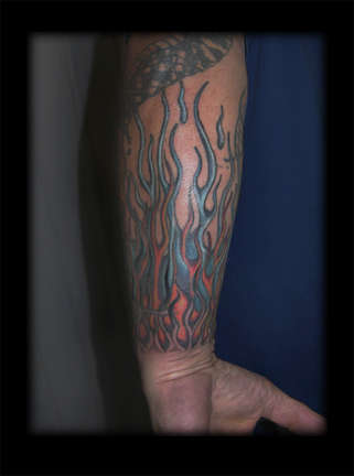 Flame/prison ink combo tattoo