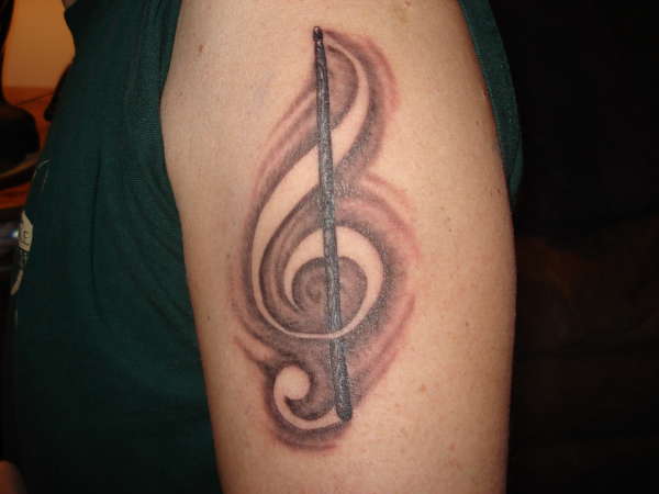 Music cleff drumstick tattoo