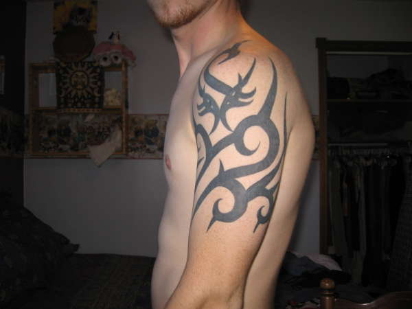 Tribal in the works side view tattoo