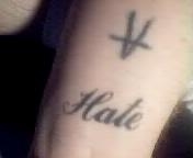hate on left wrist tattoo