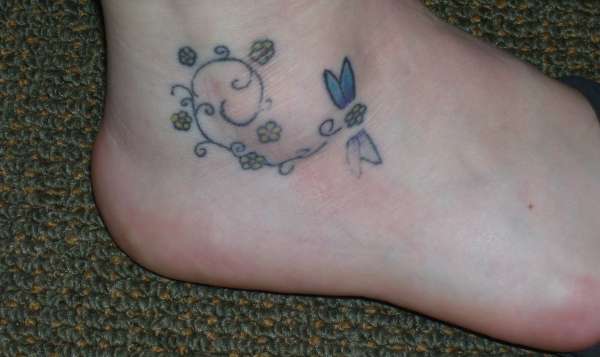 dragonfly/flowers on foot tattoo