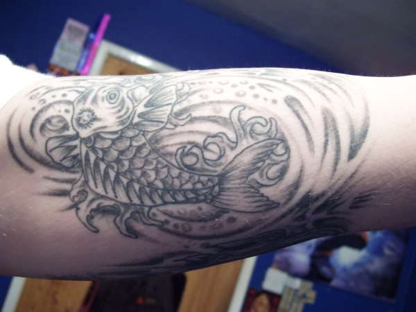Koi on arm tattoo