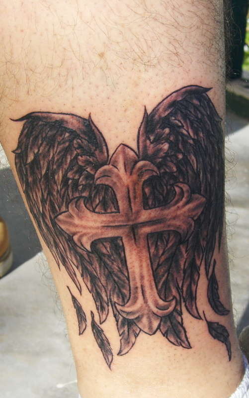 cross and angel wings on arm