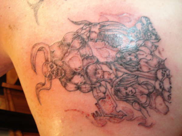 demon cutting heads off tattoo