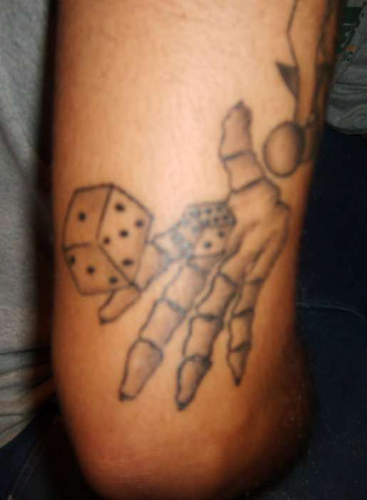 hand shooting dice tattoo