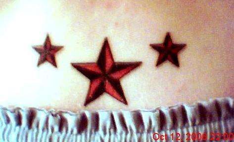 3 stars on lower back tattoo