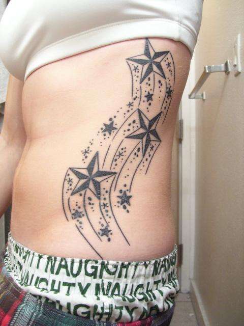 Shooting Stars up ribs tattoo