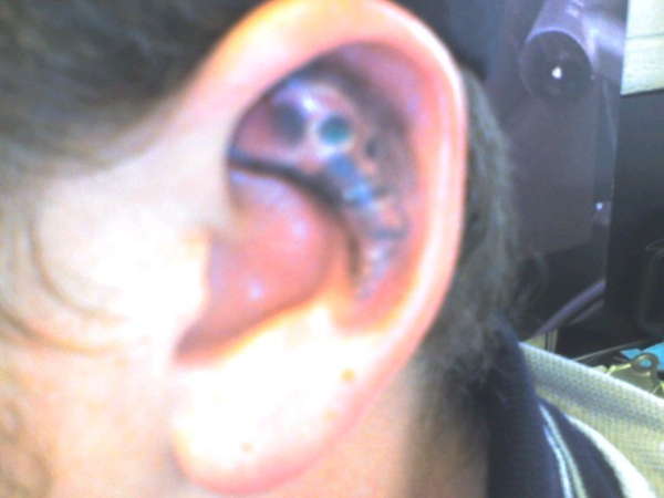 SKULL IN EAR tattoo
