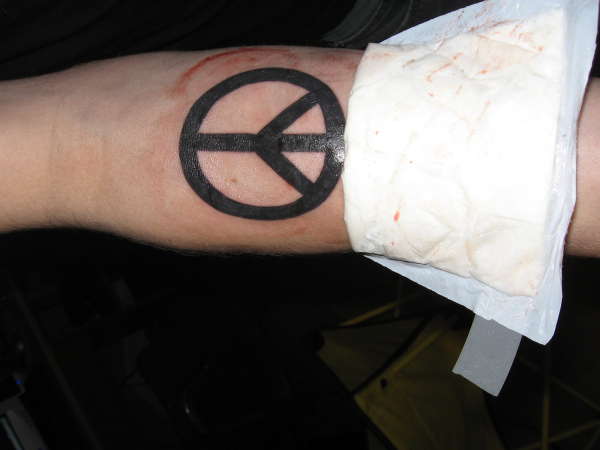 Forearm peace sign tattoo