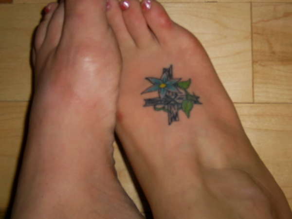 Cross on foot tattoo