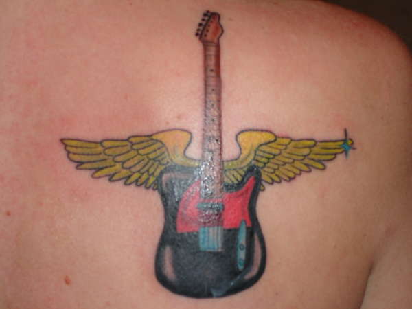 Guitar on shoulder tattoo