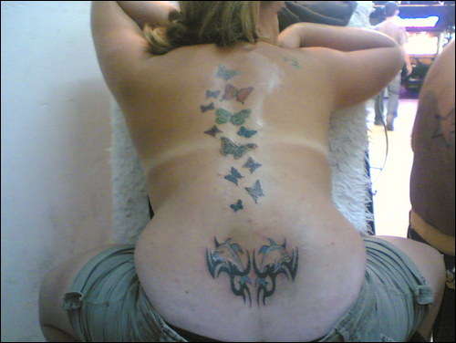 12 Butterflys Flying up my back .. Tribal Dolphin Base of Back.. tattoo
