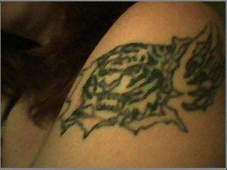 tiger ripping thru skin tattoo