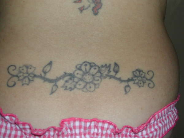Flower tattoo on lower back tattoo