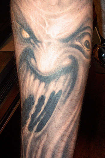 Black and Gray Forearm Ghost tattoo