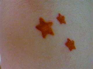 Close-up of Fuchsia Neck Stars tattoo