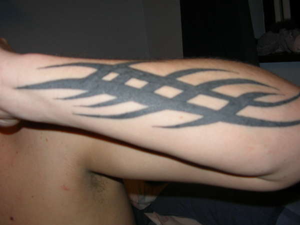 tribal left arm tattoo