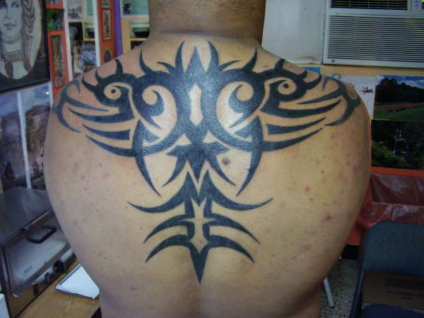 tribal mural in back tattoo