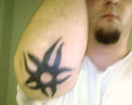 Tribal star right elbow tattoo