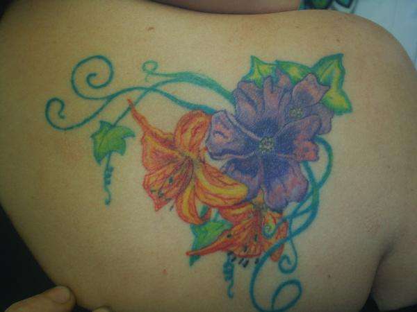 Flowery shoulder piece tattoo