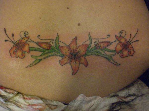 flower on lower back tattoo
