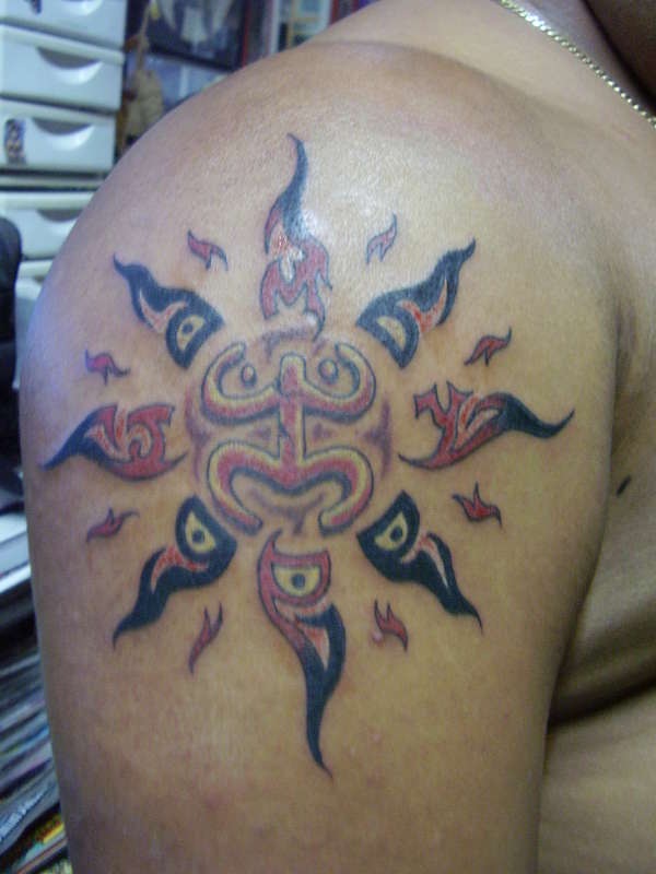 taino(coqui) petrogliphs inside the sun tattoo