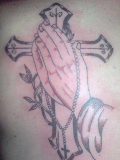Micks cross and hands tattoo
