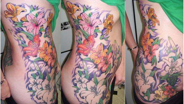 Lilies on ribs (4th sit) tattoo
