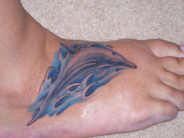 Dolphin on my foot hurt like hell tattoo