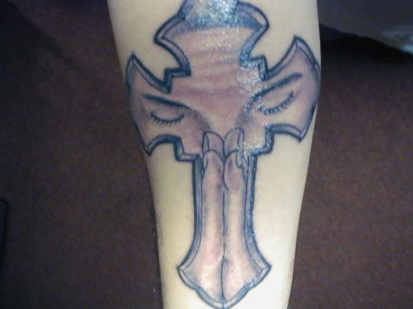praying hands and eyes in cross tattoo