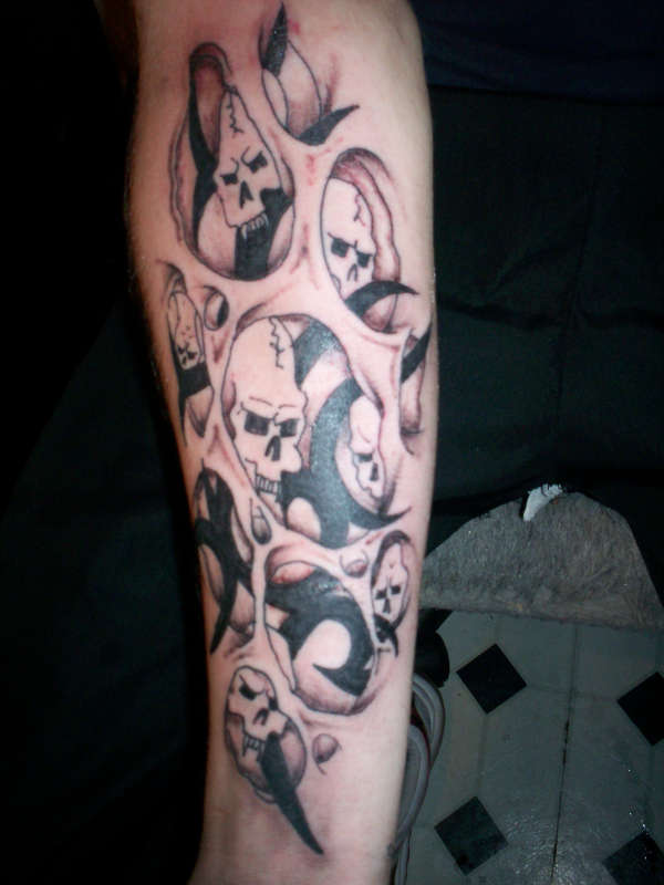 Black/grey skulls through skin holes tattoo
