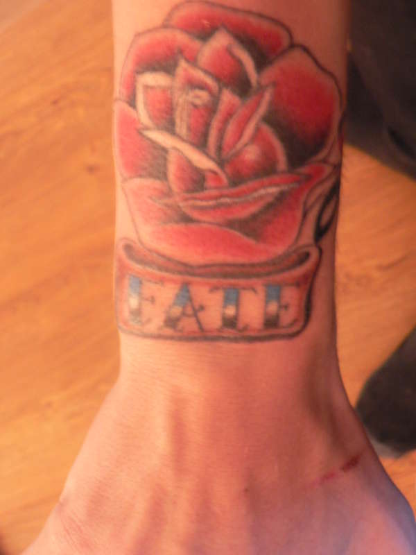 Rose with banner 'fate' tattoo