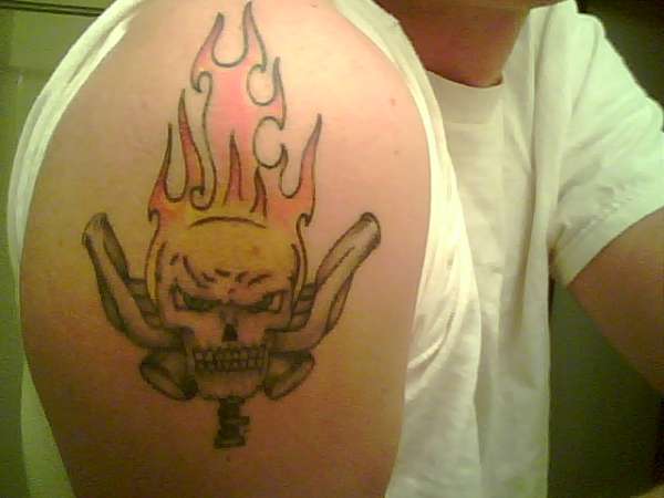 Skull, Flames, and Parts tattoo