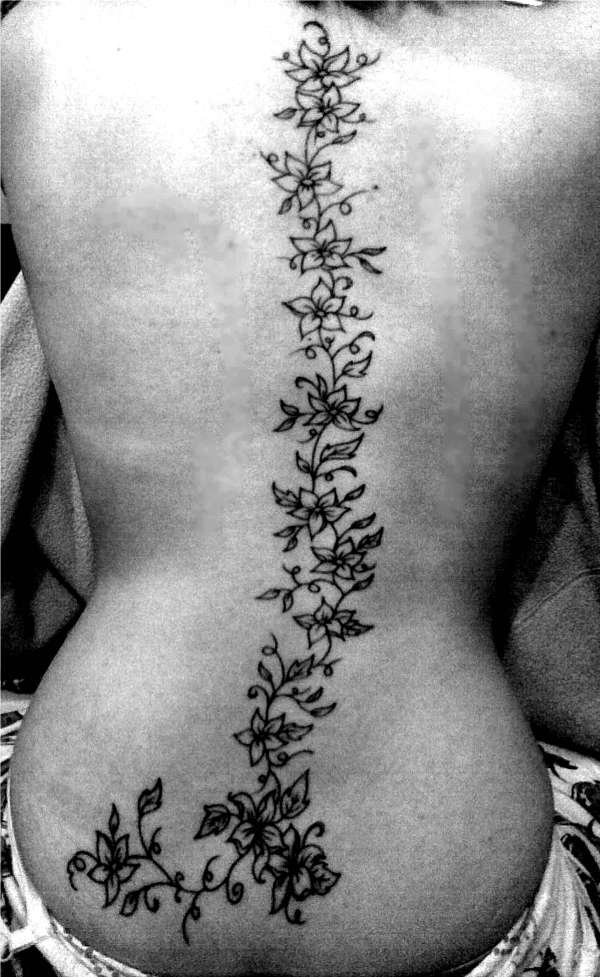 Flowers down the spine tattoo