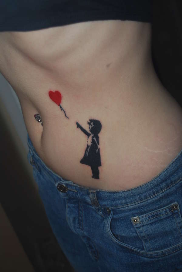 Girl with a heart balloon tattoo