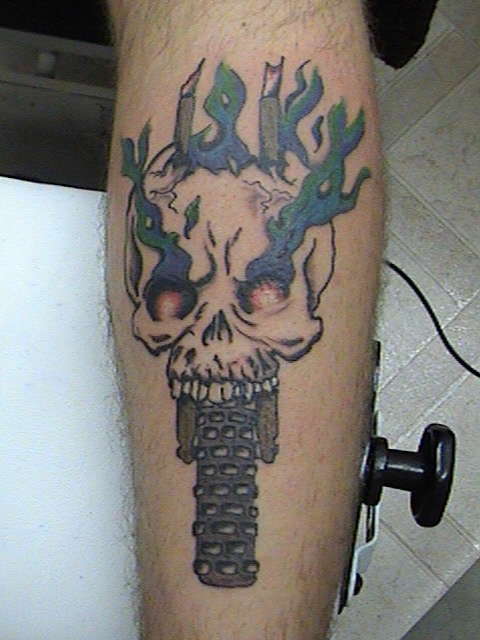 skull on dirt bike wheel tattoo