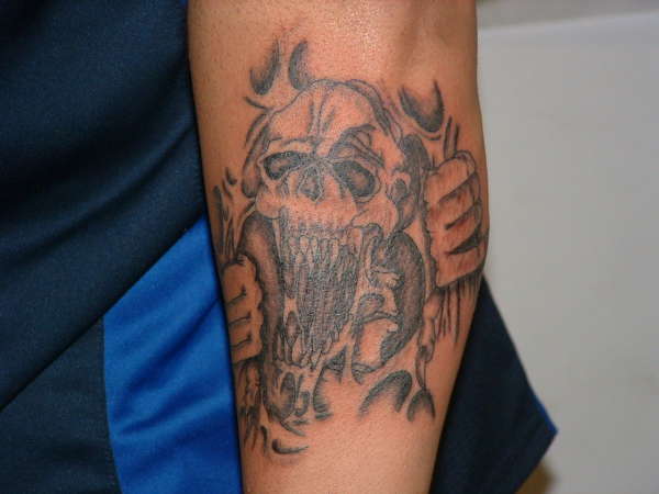 skelton riping skin tattoo