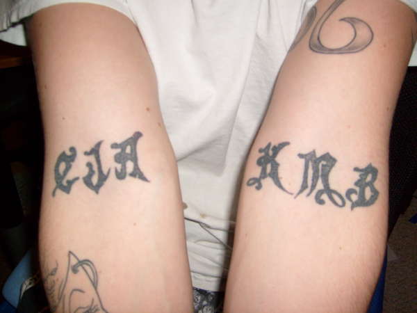 Initials on Pits tattoo