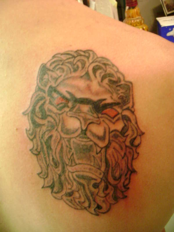 Lion in stone tattoo