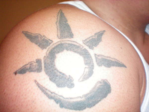 Savage glyphic tattoo