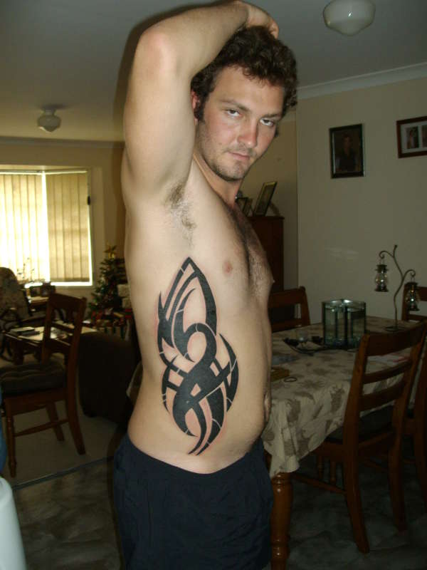 side of body tribal tattoo