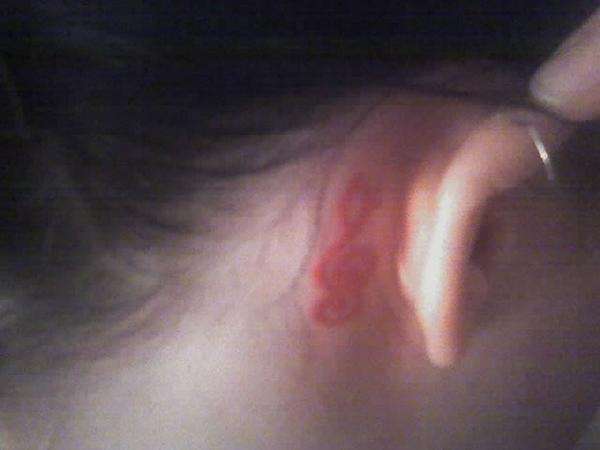 Treble clef behind right ear. tattoo