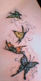 Four butterflies swirling upwards tattoo