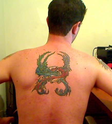 Two Dragons around a ball tattoo